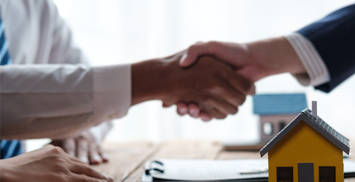 Photo of person shaking hands with real estate agent